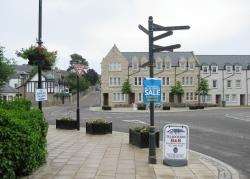 Two of the many advertising signs in Dornoch's town square