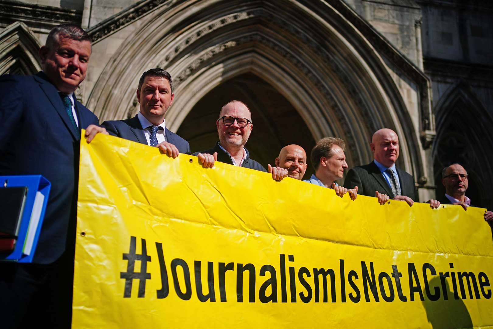 Barry McCaffrey, centre, and Trevor Birney, third left, with lawyers and supporters outside the Royal Courts of Justice in London (Victoria Jones/PA).