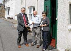 Councillor Ian Ross presents Mr and Mrs James Shaw of Dornoch with their prize draw vouchers