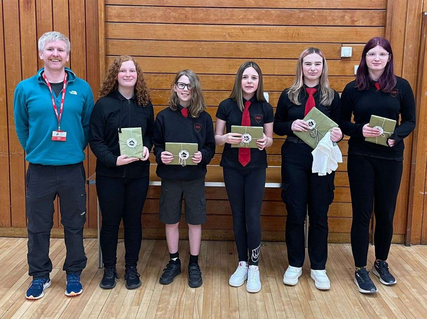 Ken with Golspie pupils Aoife Lee, Angus Masson, Stacie Taylor, Lola Greaves and Rosalie Siby, who all took part in the JOGT stamps competition.