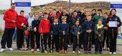 Duncan (far left) and Sophie (far right) with some of the shinty players they coach.