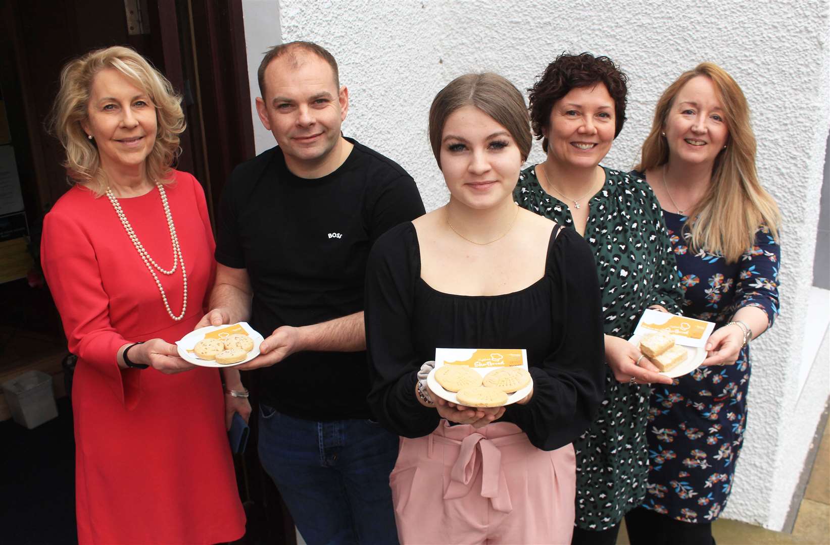 Ellie Lamont (left) and Cathy Earnshaw (right) of Venture North with Shortbread Showdown judges Gary Reid, Iona Simpson and Donna Booth outside Mackays Hotel. Picture: Alan Hendry