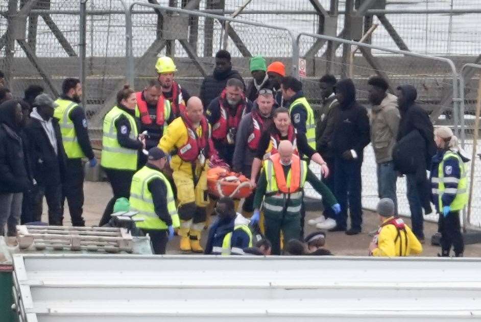 Crews carried someone ashore on a stretcher as migrants arrived in Dover on Tuesday (Gareth Fuller/PA)