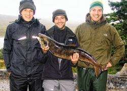 Simon Wirries (centre) shows off his 16lb 2oz trout, together with Sebastian and Daniel Ernst.