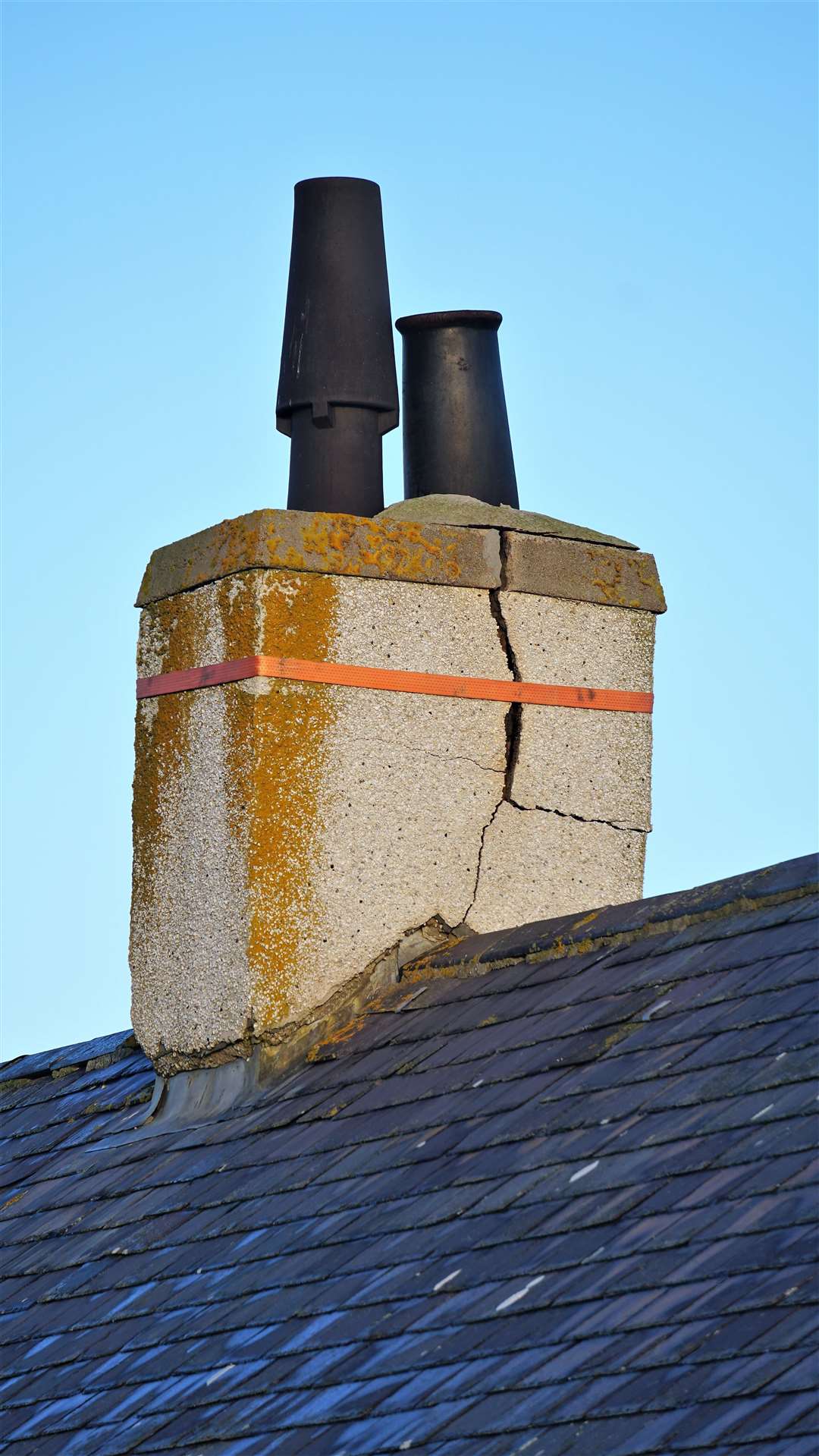 The cracked chimney stack at the Nicolson household which has steadily declined over the past six years. The council has fitted a ratchet strap to maintain some structural integrity but Mr Nicolson claims fire service personnel said it was dangerous and could collapse at any moment. Picture: DGS