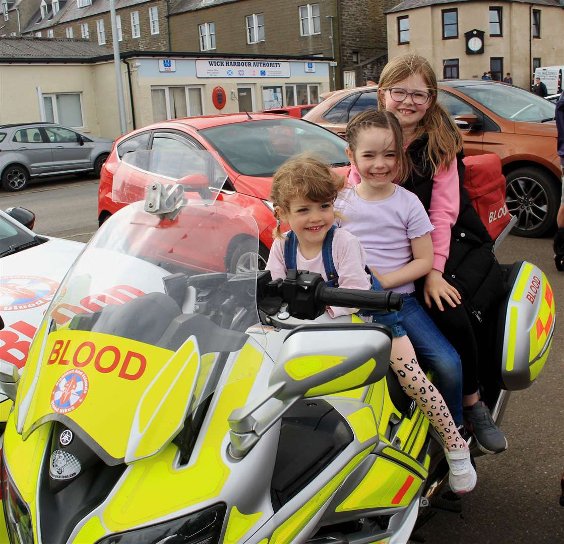 Cammie Mackay (3), Hannah Mackay (6) and Leah Mackay (8) on a Highland and Islands Blood Bikes motorcycle. Picture: Alan Hendry