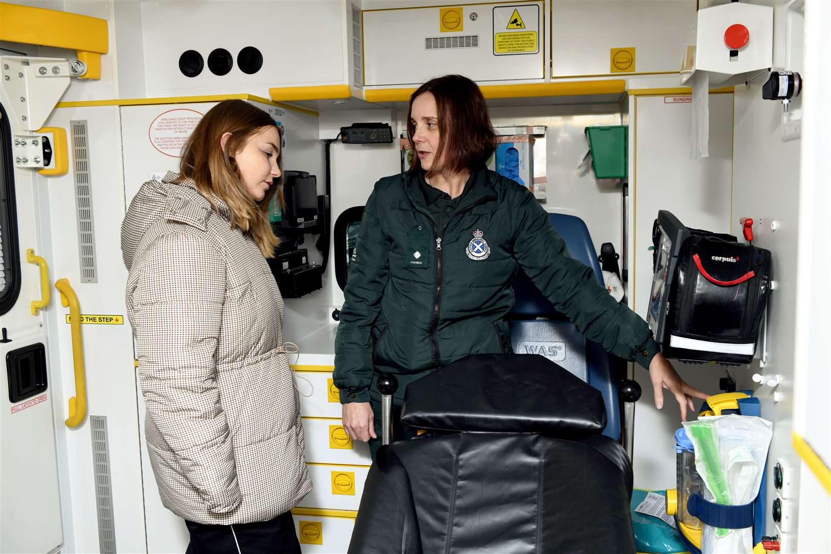 Heather showing Annabelle the equipment in the ambulance.
