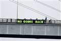Banner draped on Highland capital bridge by protestors to highlight climate crisis 