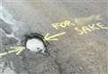 Disgruntled spray painter makes feelings know about potholes on north roads
