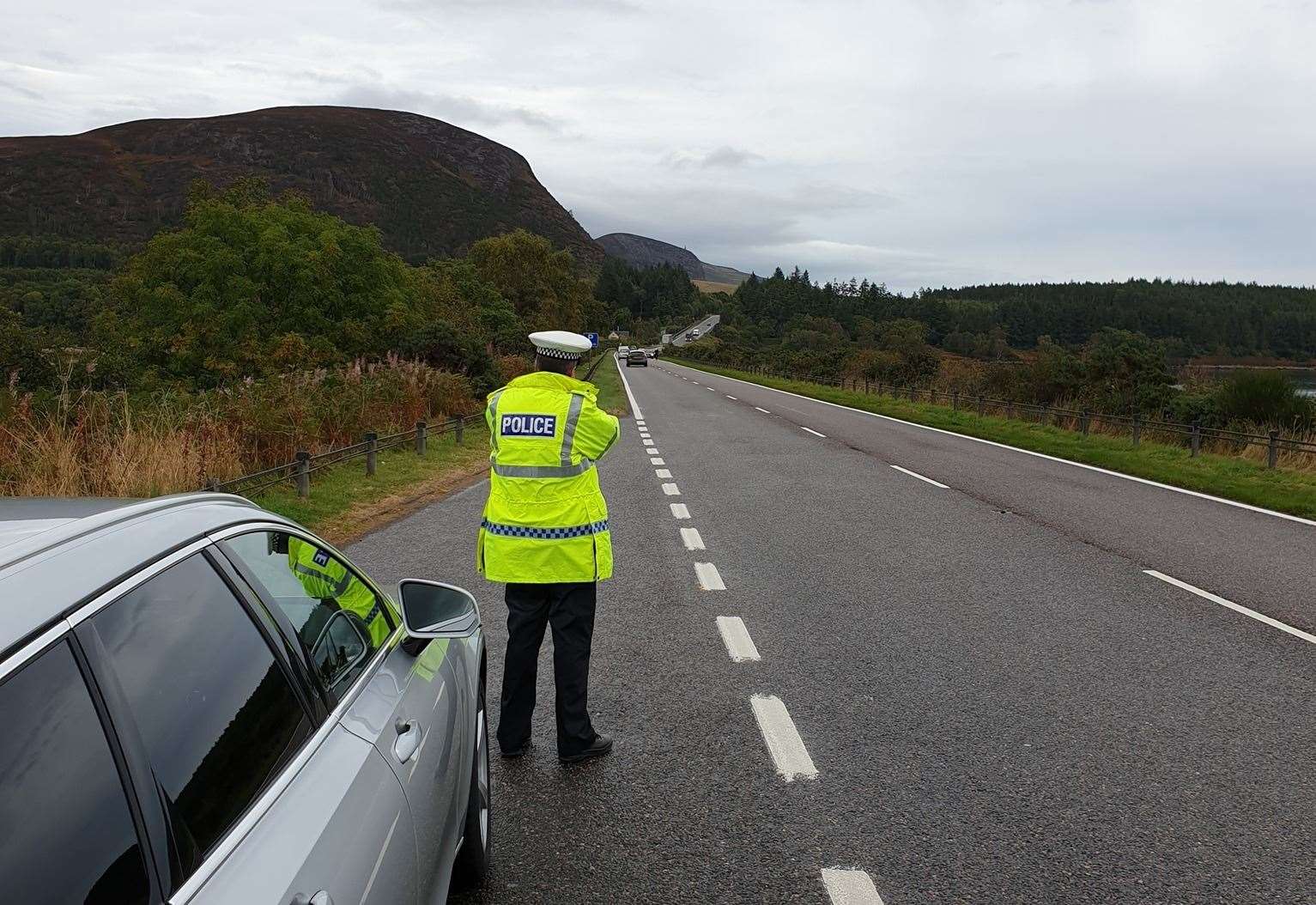A police officer using a speed gun at The Mound on the shores of Loch Fleet in Sutherland. Picture: Police Scotland.