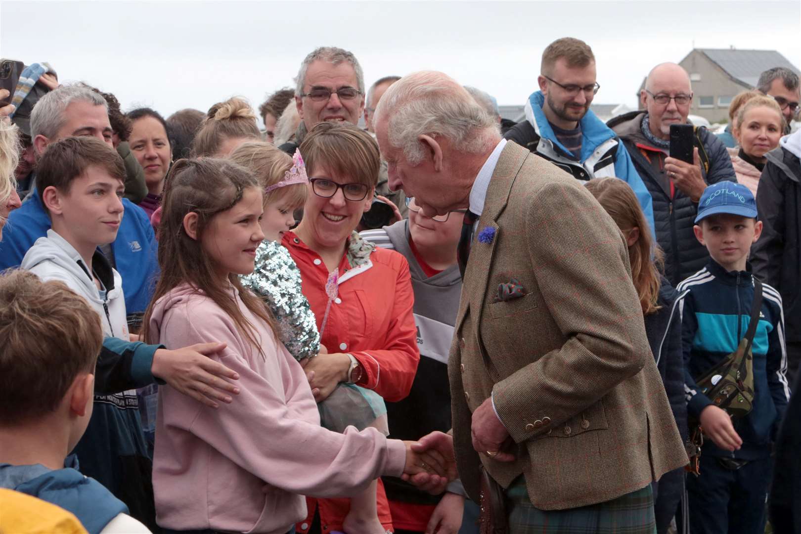 A crowd of onlookers gathered in the drizzle to see the royal visitor. Picture: PA