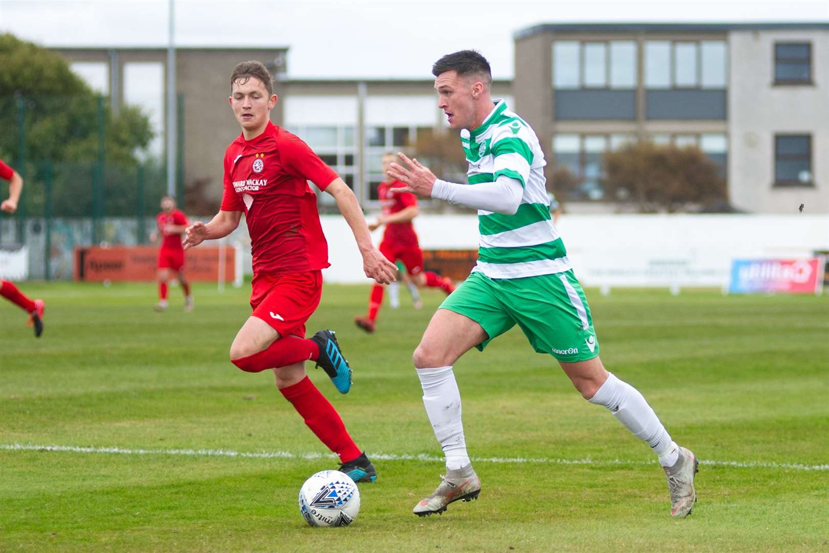 Buckie Thistle forward Steven Ross is tracked by Brora Rangers' Miller Gamble. ..Brora Rangers FC (2) vs Buckie Thistle FC (2) - Buckie win 4-3 on penalties - Highland League Cup Semi Final - Dudgeon Park, Brora 18/10/2020...Picture: Daniel Forsyth..