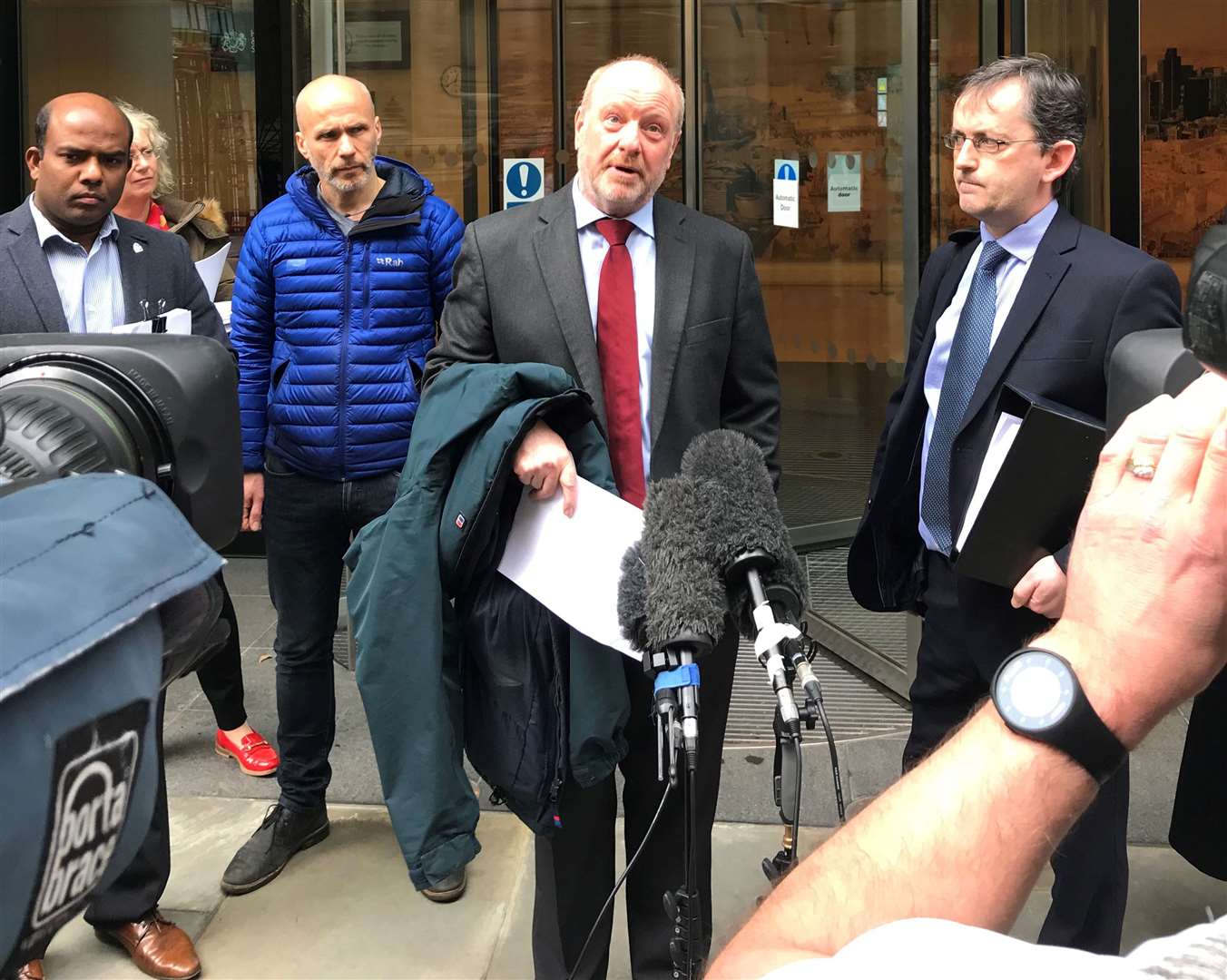 Alan Bates (centre) speaking outside the High Court in London, after the first judgment was handed down in claims against the Post Office over its computer system (Sam Tobin/PA)