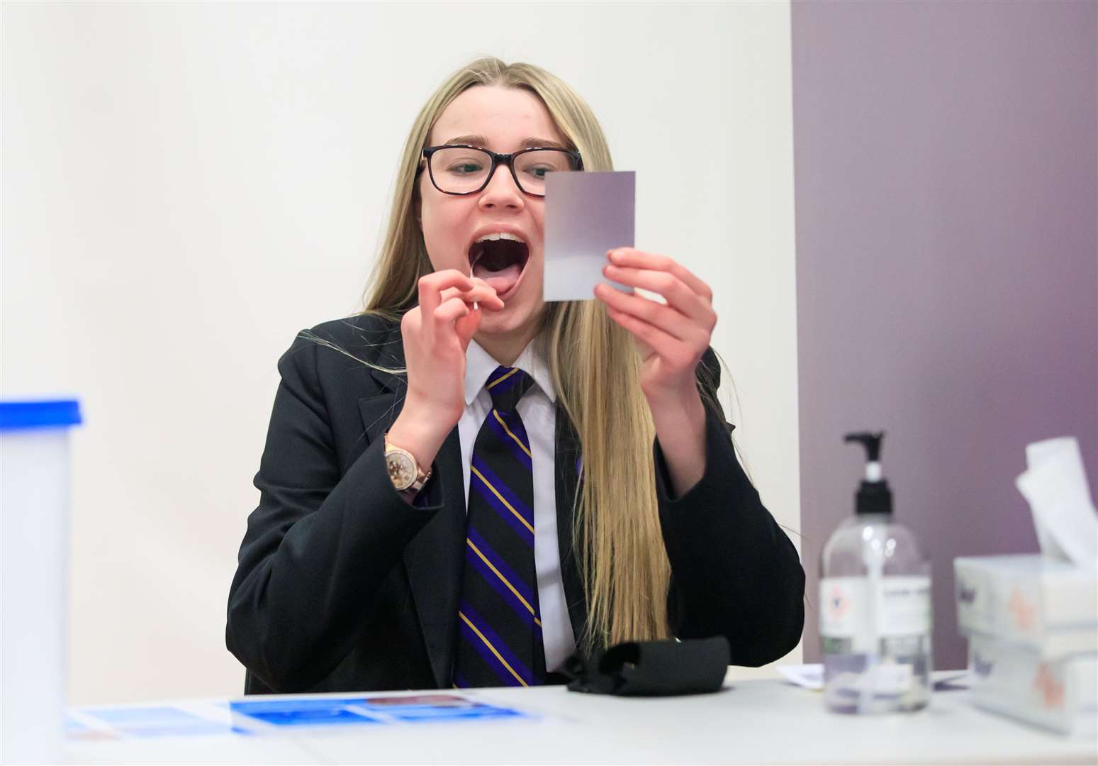 Erin Horn looking in a mirror while taking a Lateral Flow Test at Outwood Academy in Woodlands, Doncaster (Danny Lawson/PA)