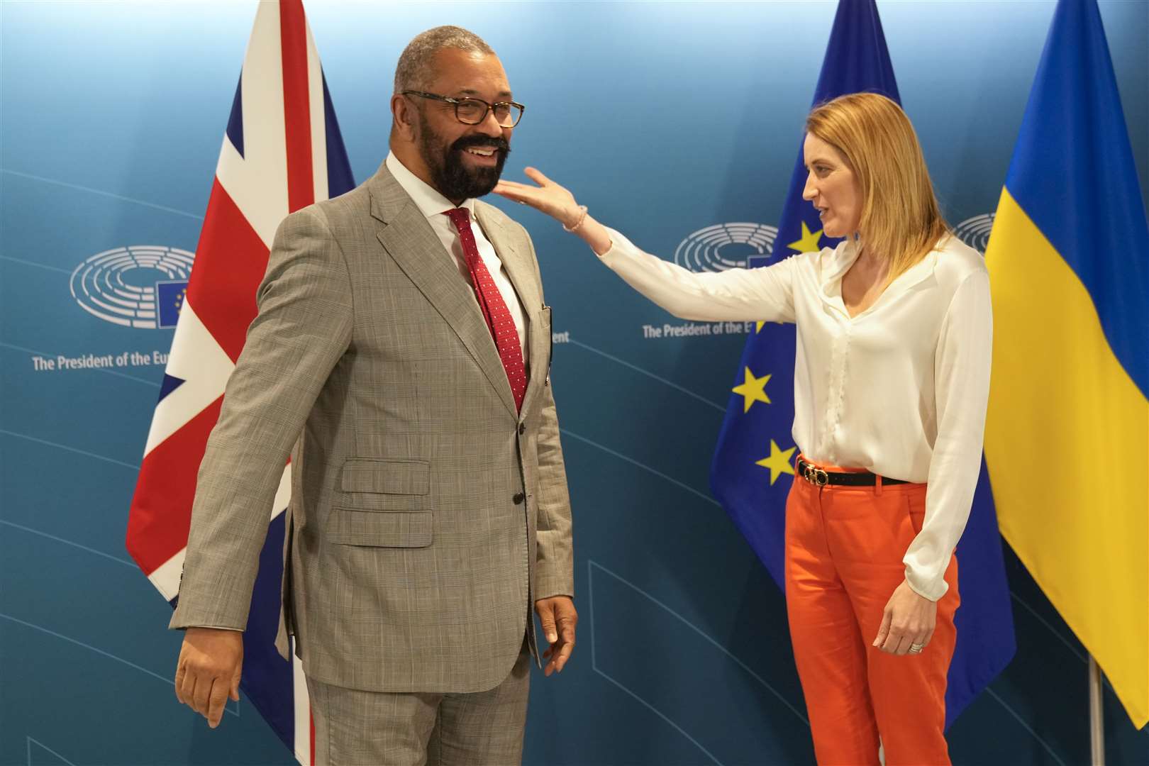 Mr Cleverly is greeted by European Parliament President Roberta Metsola (AP)