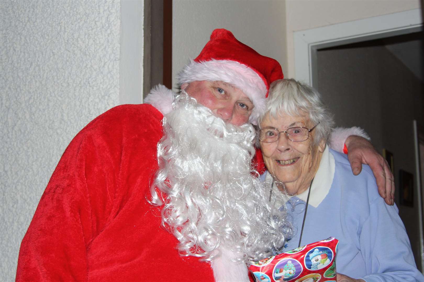 Santa gives Mary Shearsmith a Christmas cuddle.