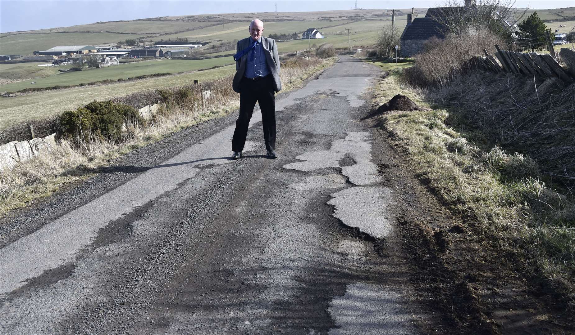 Iain Gregory of Caithness Roads Recovery pointing out the potholes at Braeside Retreats, Sibmister, earlier this year.