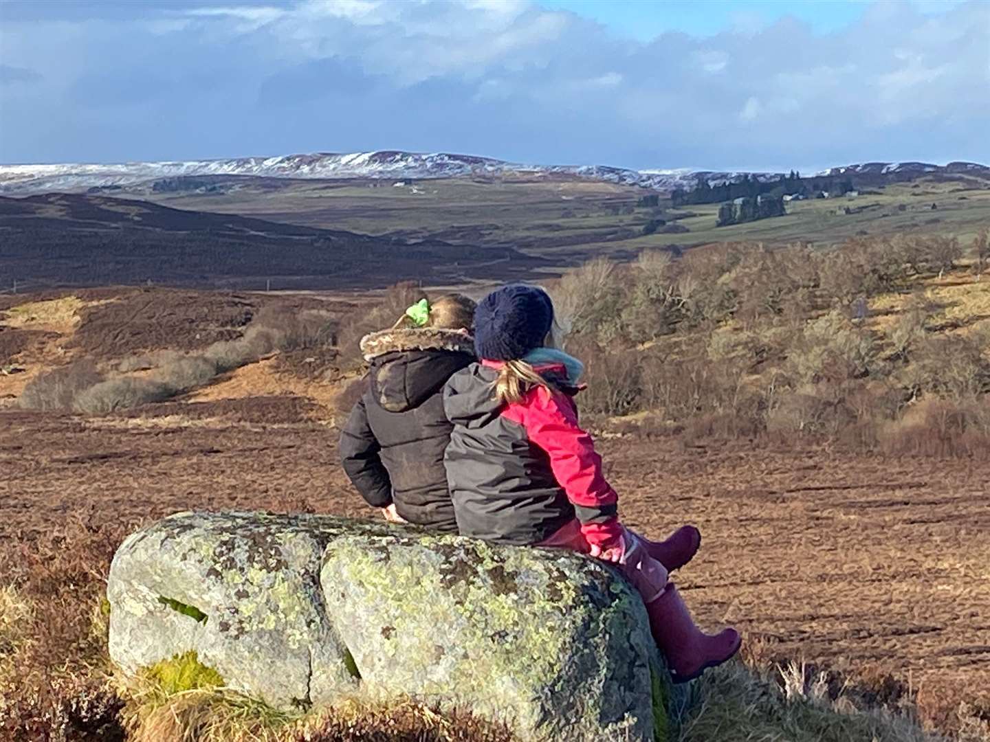 Taya Meldrum-Butcher and Lexi Mackay perch on a rock and enjoy the beautiful view.