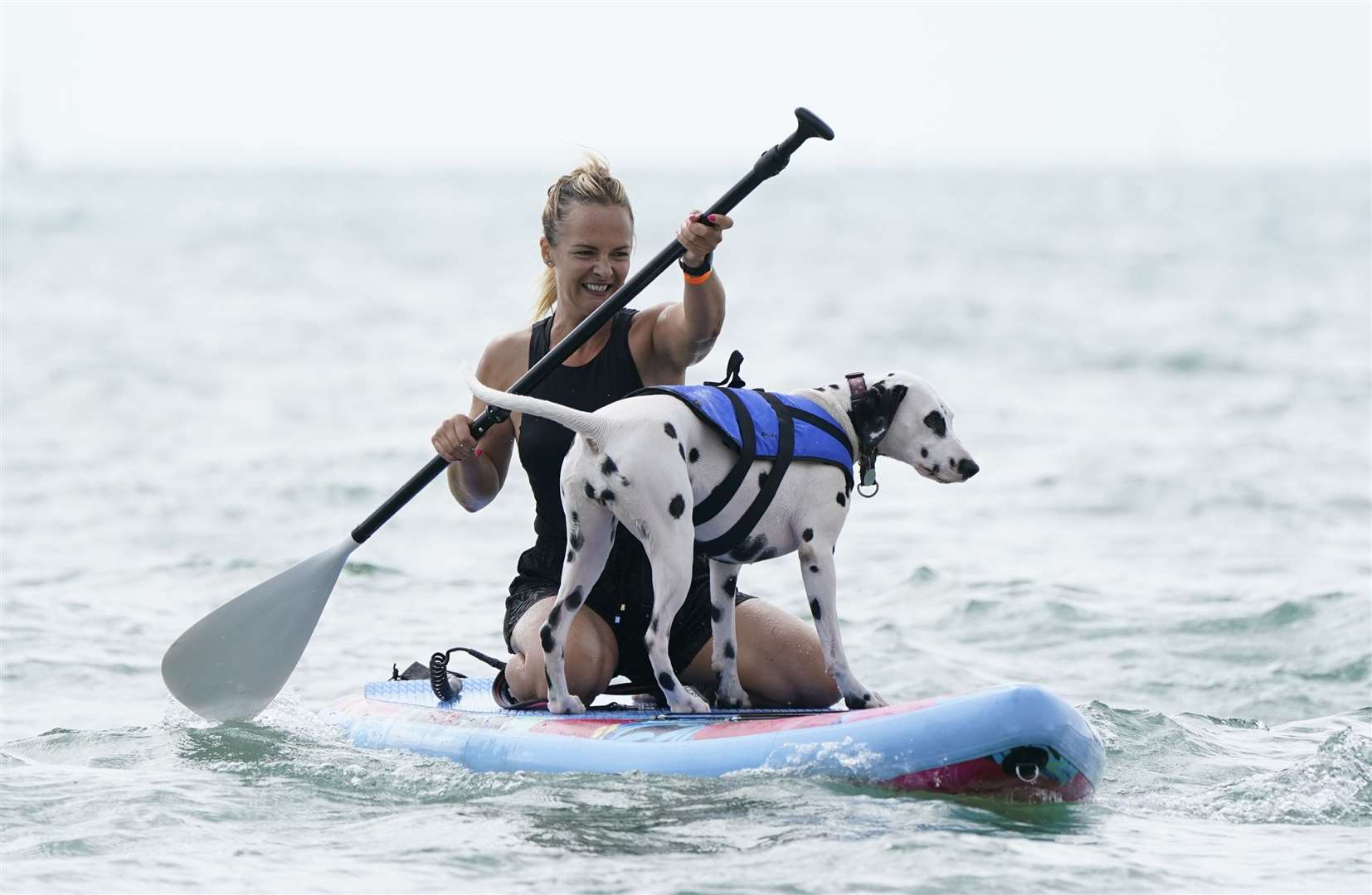 Marina White and her pet Coco took part in the Dog Masters 2022 UK Dog Surfing Championships at Branksome Dene Chine beach in Poole, Dorset (Andrew Matthews/PA)