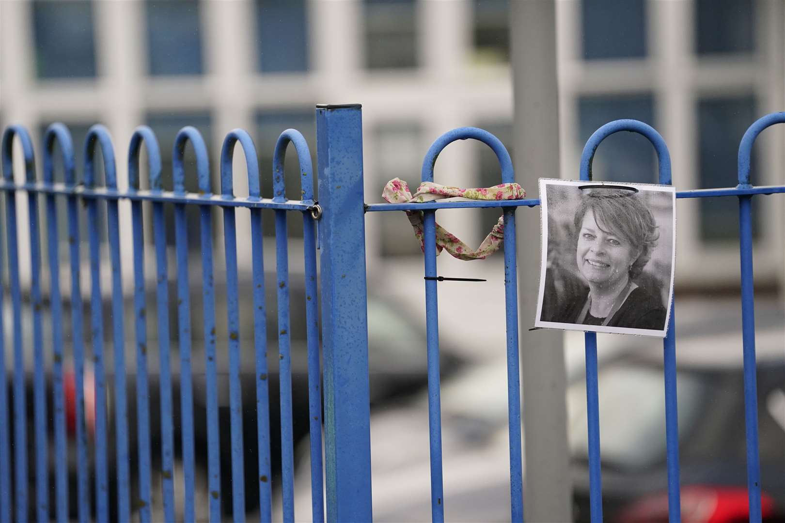 A photograph of Ruth Perry attached to the fence outside a school (Andrew Matthews/PA)