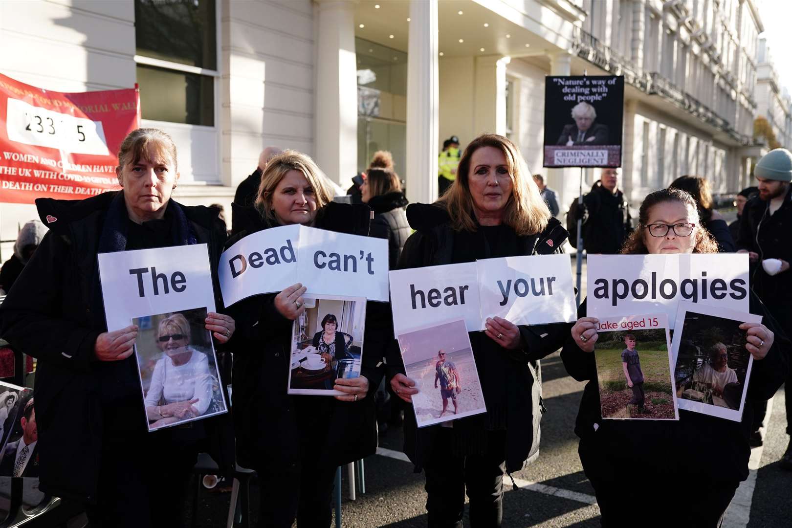 Protesters outside Dorland House after being removed from Boris Johnson’s hearing for holding up signs (Jordan Pettitt/PA)