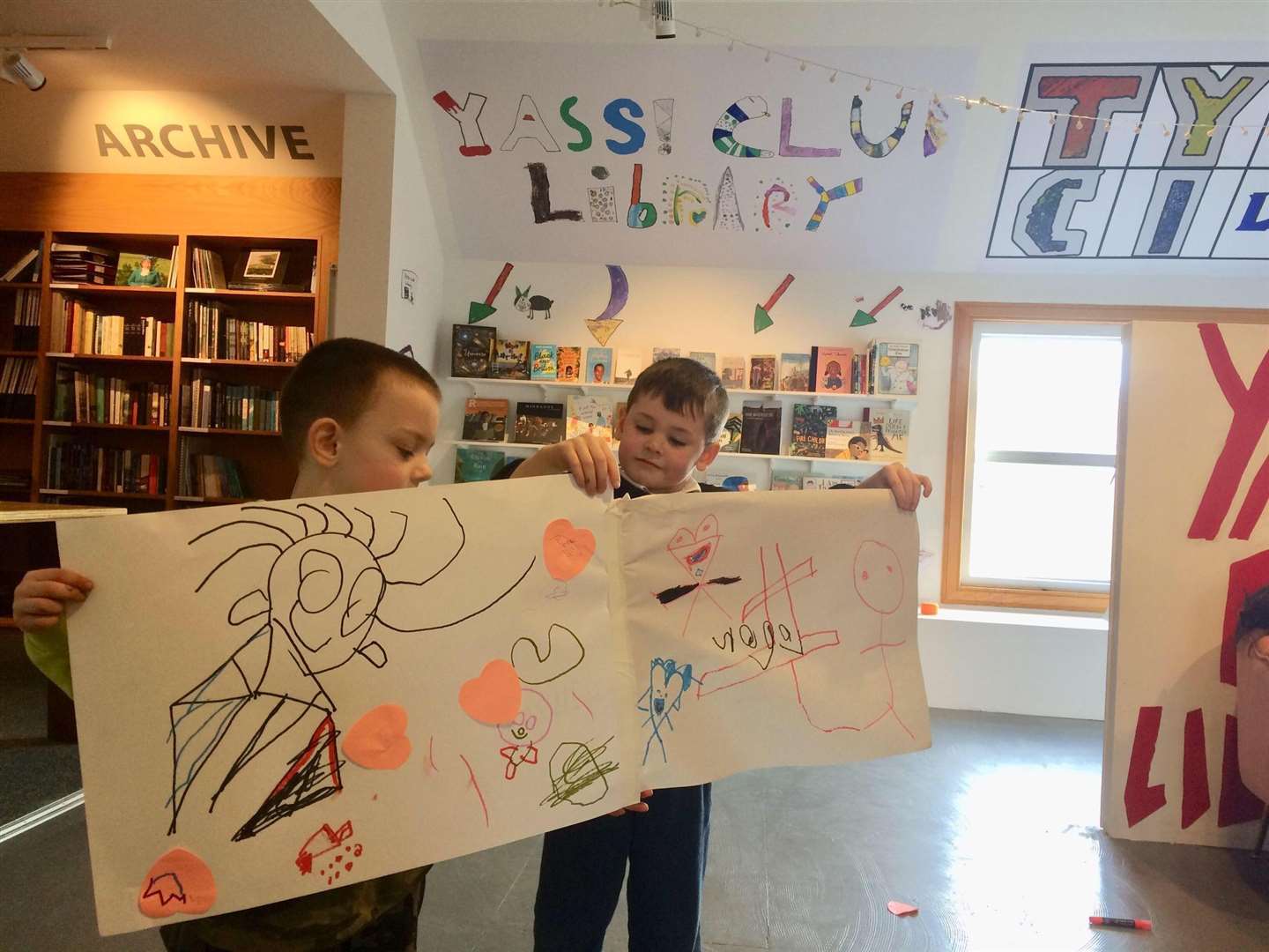 Archie Bain (left) and Logan Ogilvie put the finishing touches to the library decorations.