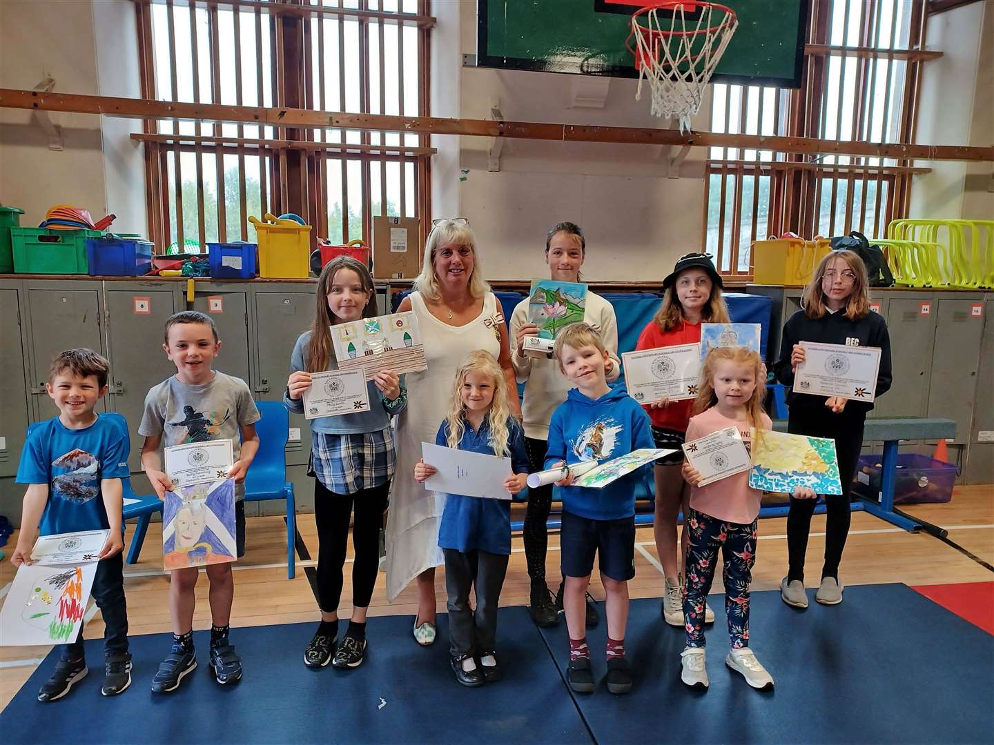 Vice Lord-Lieutenant Kim Tulloch with the winning pupils at Dornoch Primary School – Oli Whiteman (nursery); Henry MacCarthy (P1-3); and Maisie Levens (P4-7) – as well as pupils who received head teacher's special awards.