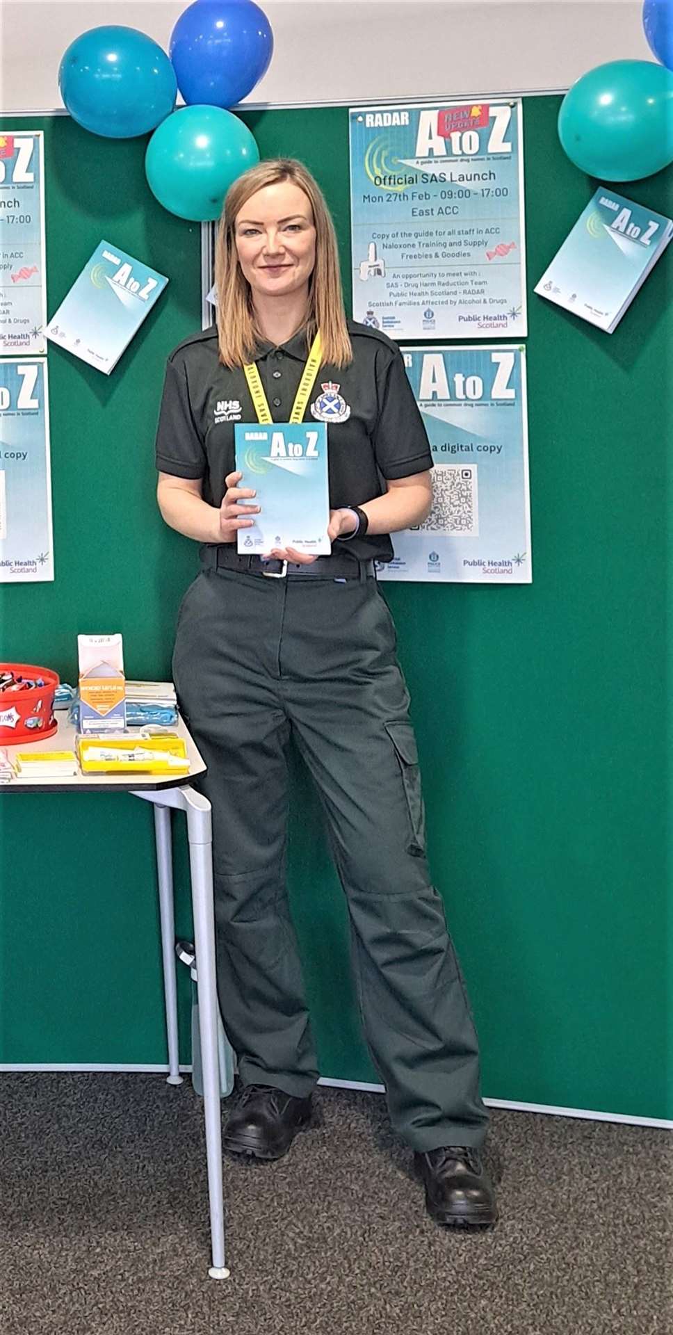 Clinical effectiveness lead for drug harm reduction, Julie McCartney with the A to Z book which provides an index for common drug terms.
