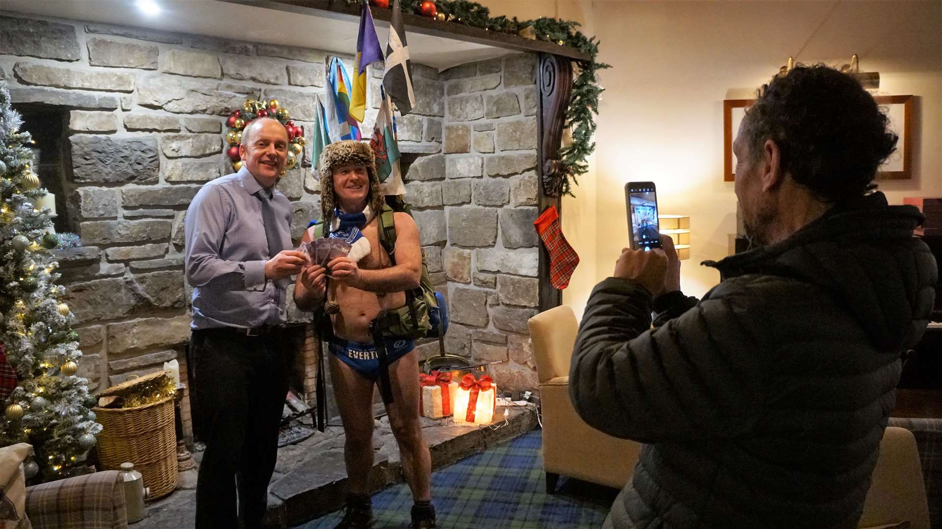 Mick's friend Paul, who is accompanying him on the journey, takes a photo of the charity walker with Andrew Mackay from the Norseman Hotel. Picture: DGS