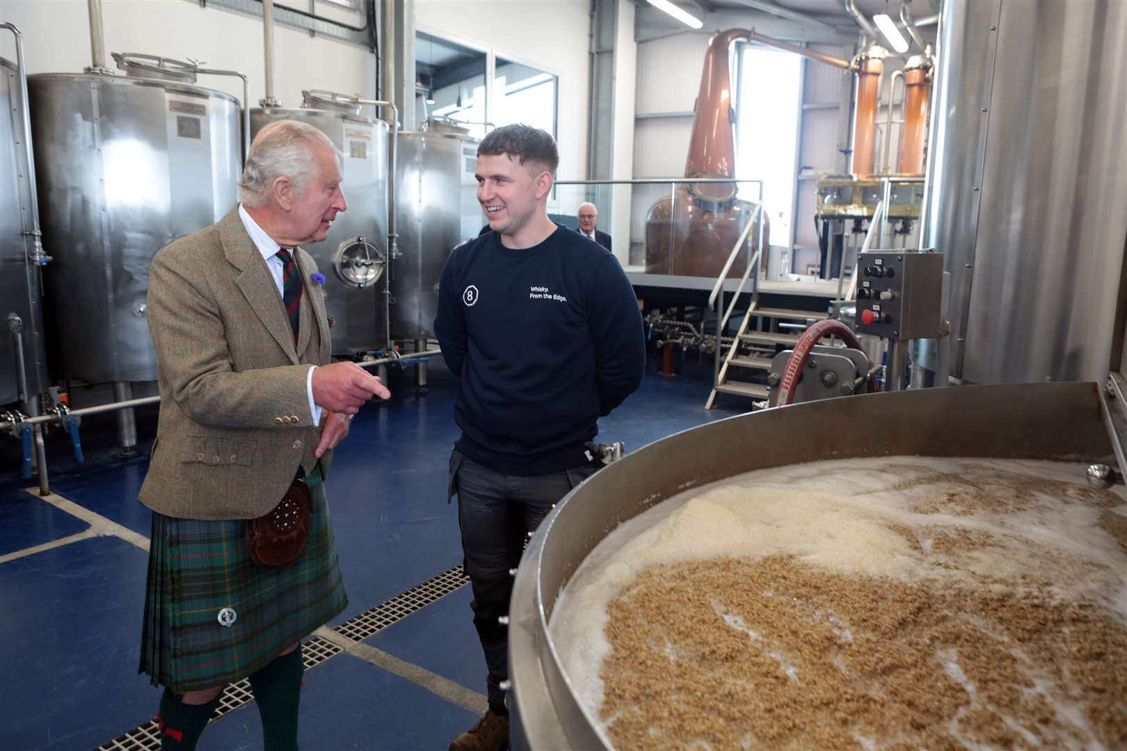 The King learns about the whisky-distilling process. Picture: PA