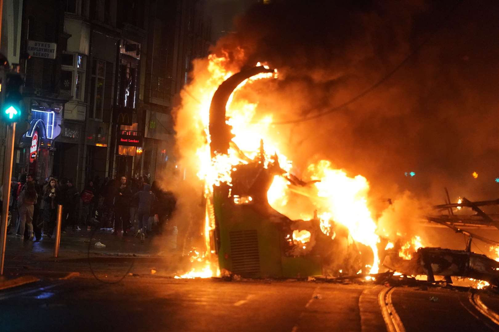 A bus on fire on O’Connell Street in Dublin (Brian Lawless/PA)
