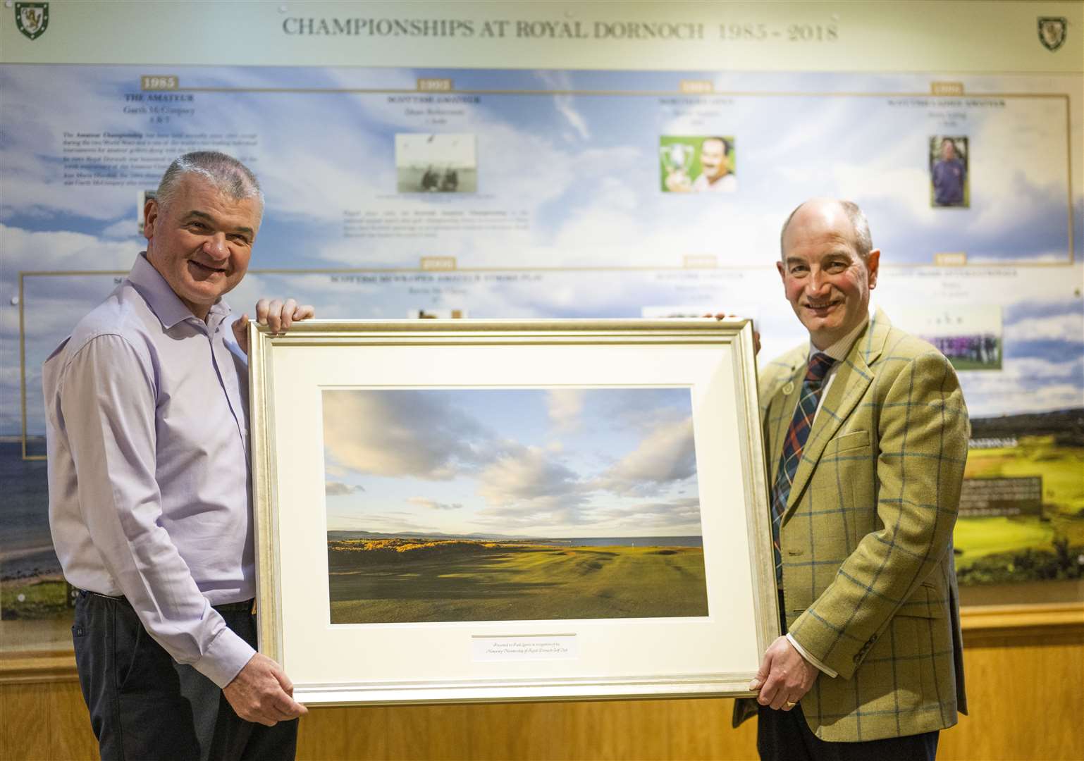 Royal Dornoch Golf Club general manager Neil Hampton presents new honorary member Paul Lawrie with a framed print of the championship course. Picture: Matthew Harris/Golf Picture Agency