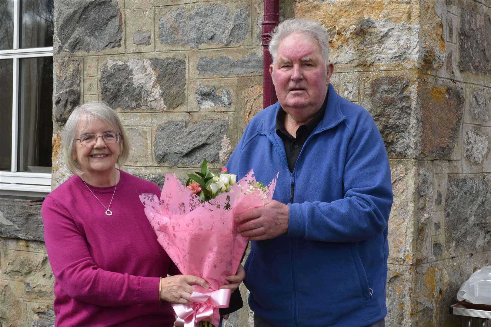 Morag Macleod, sub-postmistress at Strathnaver Post office for the last 37 years, receives a bouquet of flowers from her next door neighbour, eighty-five year old Ian (Inshlampie) Mackay. Picture: Jim A Johnston