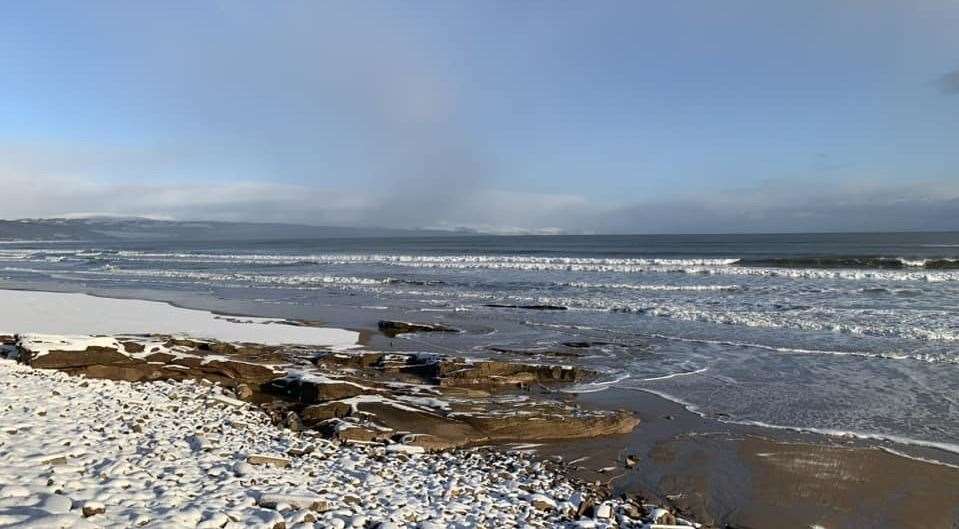 The shores of Embo beach with the frothy waves meeting the snow. Photo: Debbie Ross