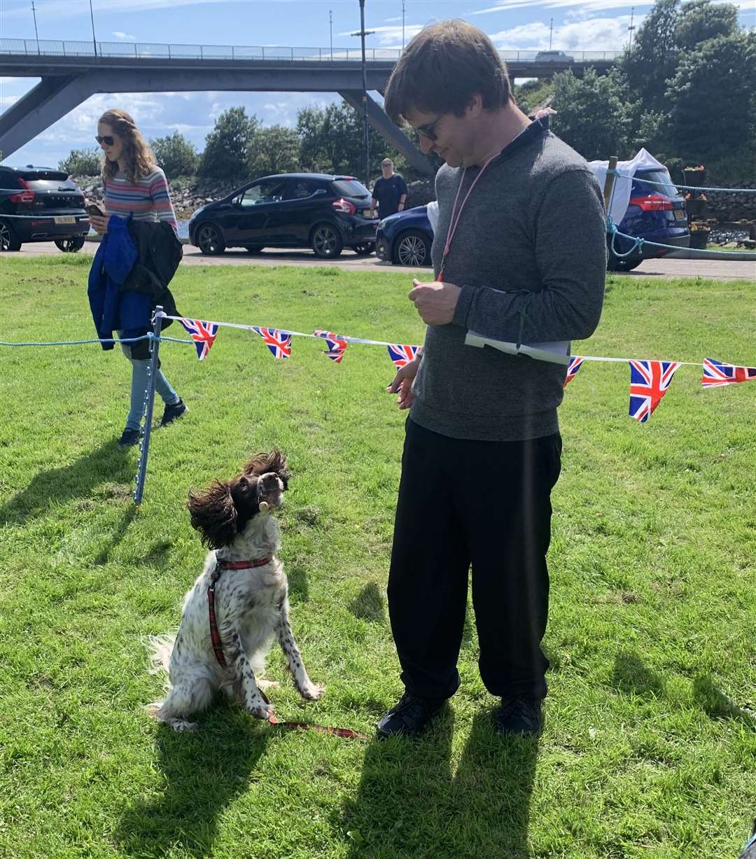 Gracie the springer spaniel demonstrating her biscuit catching skills alongside owner David Baines from Brora.