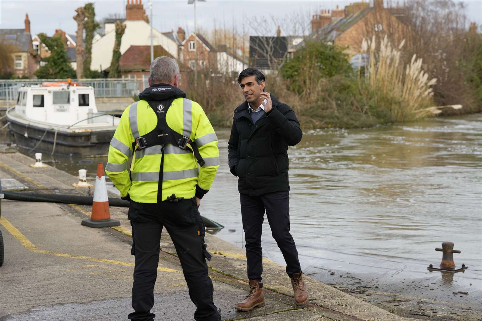 Prime Minister Rishi Sunak speaks to a member of the Environment Agency as he looks at flood defences during a visit to Osney, Oxford, Oxfordshire (Frank Augstein/PA)
