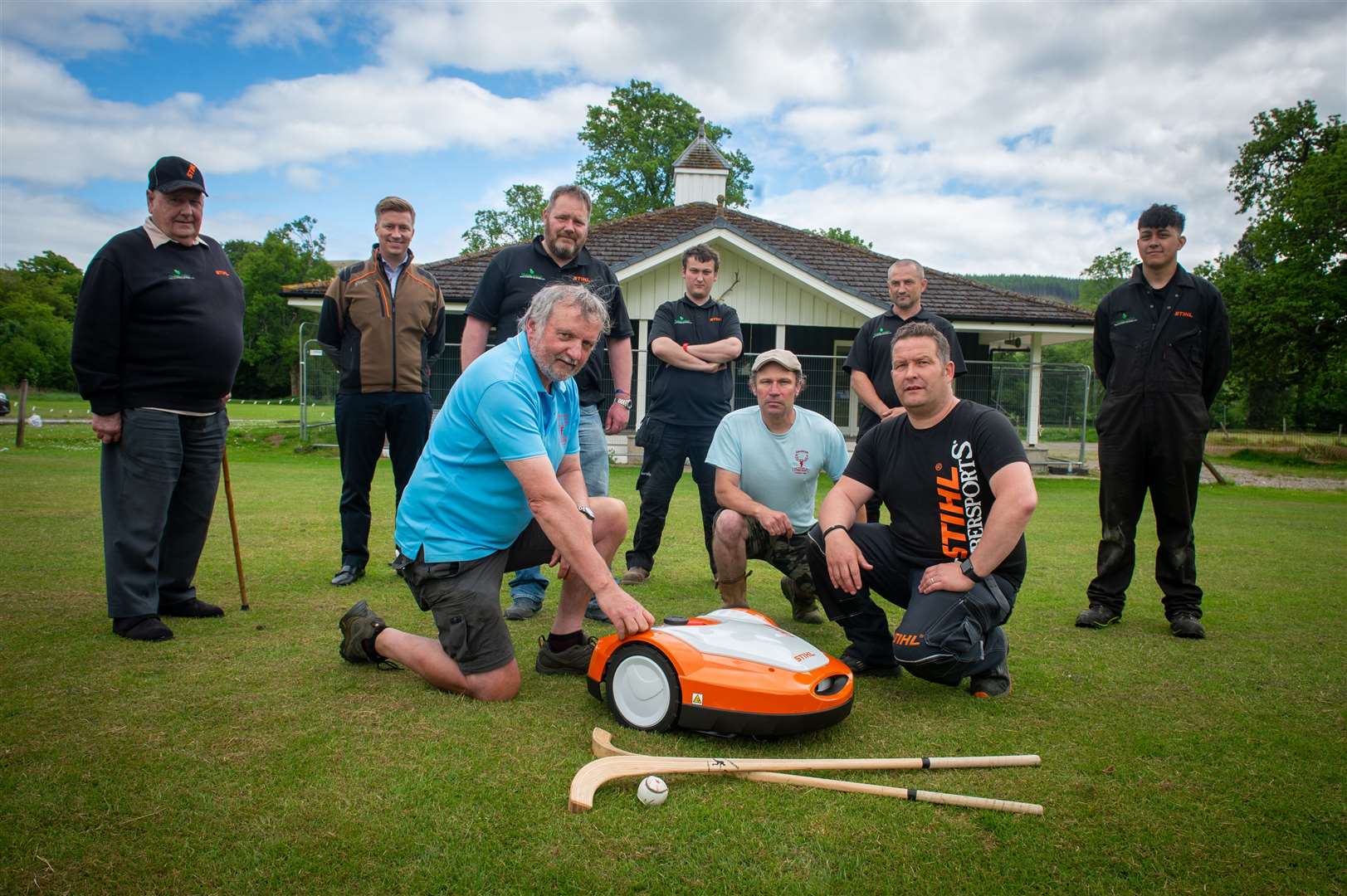 Caberfeidh Shinty Club gets a new robotic lawnmower. Pictured (front) Ian MacLean, club president, John Macpherson, committee member with Stuart Wharm from STIHL with the Frank Nicol team behind. Picture: Callum Mackay
