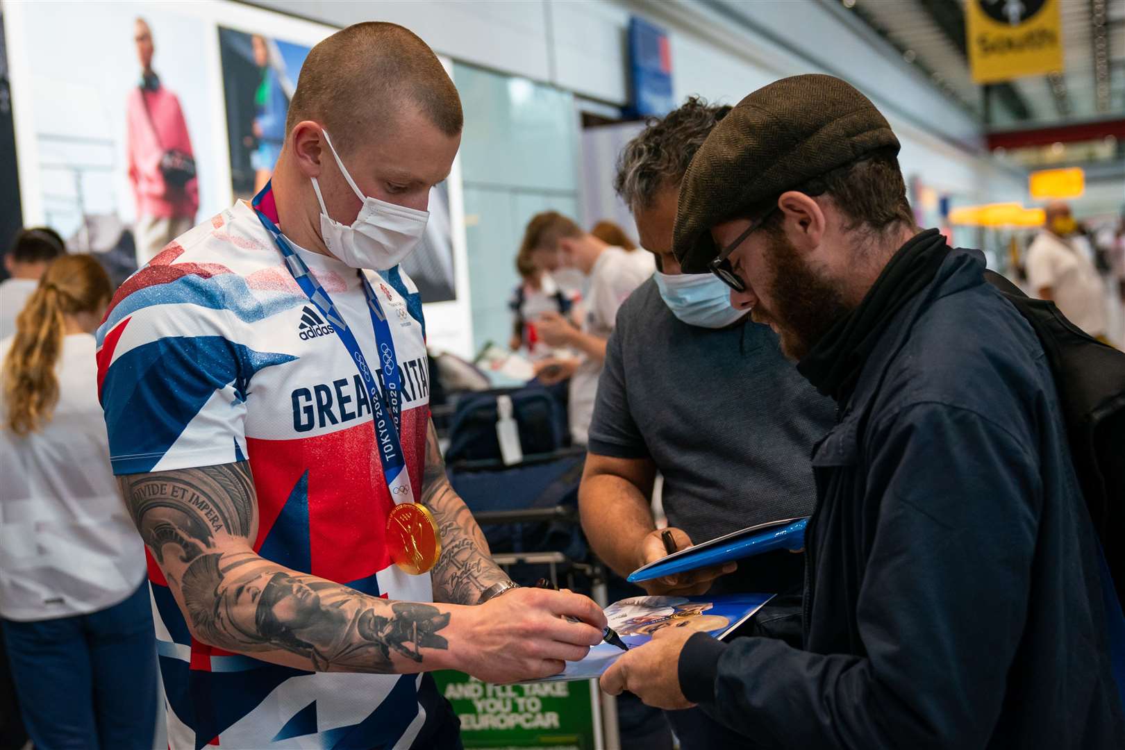 Adam Peaty sign autographs at Heathrow Airport (Aaron Chown/PA)