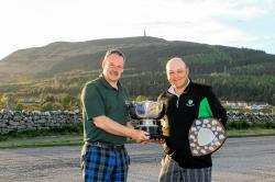 Golspie Golf Club captain William MacBeath congratulates Brian Urquhart on his Millicent Bowl win