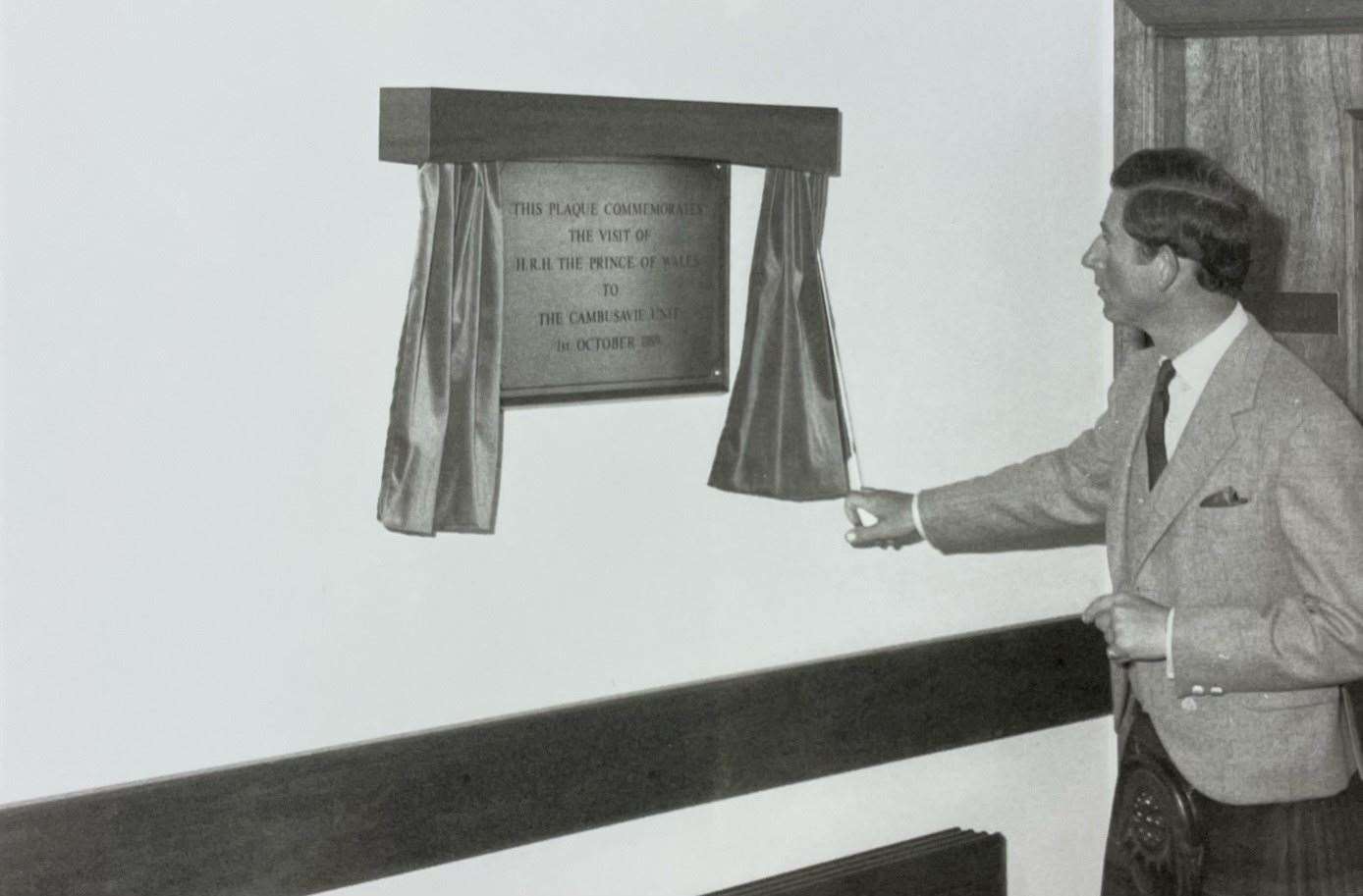 Prince Charles unveils a plaque commemorating his visit to the Lawson Memorial Hospital, Golspie.