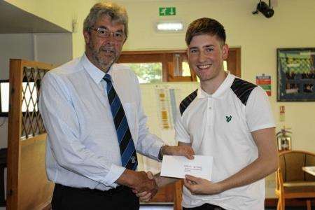 Graeme Bethune receiving his prize from Elgin captain Dave Masson.