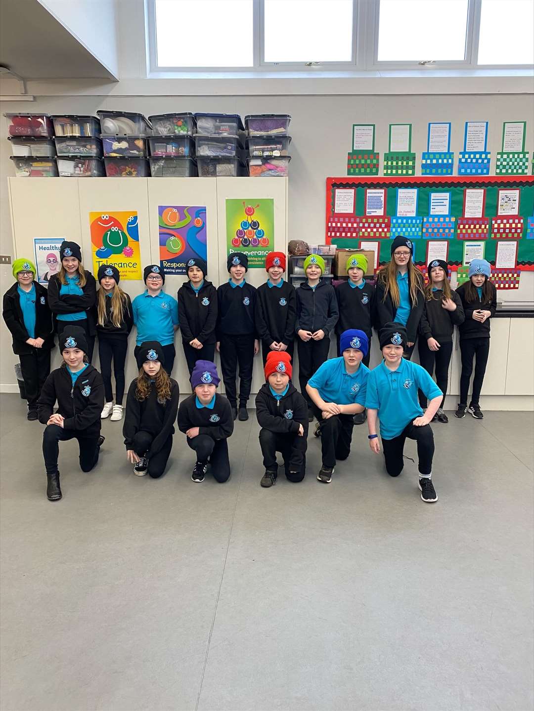 P4-7 pupils in their new hats which were provided by the pupil council, who raised £70 by holding a uniform sale.