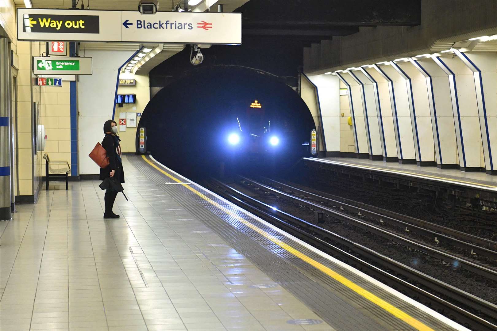 A woman waiting at Blackfriars Tube station (Dominic Lipinski/PA)
