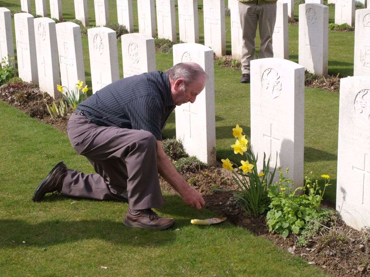 Alasdair Sutherland in 2010 on the trip organised by Clyne Heritage Society at the grave of his uncle at Dartmoor cemetery near Albert on the Somme.