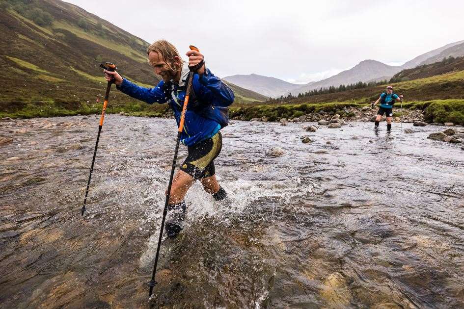 Crossing a river on day three of CWU2022 - ©Cape Wrath Ultra & No Limits Photography