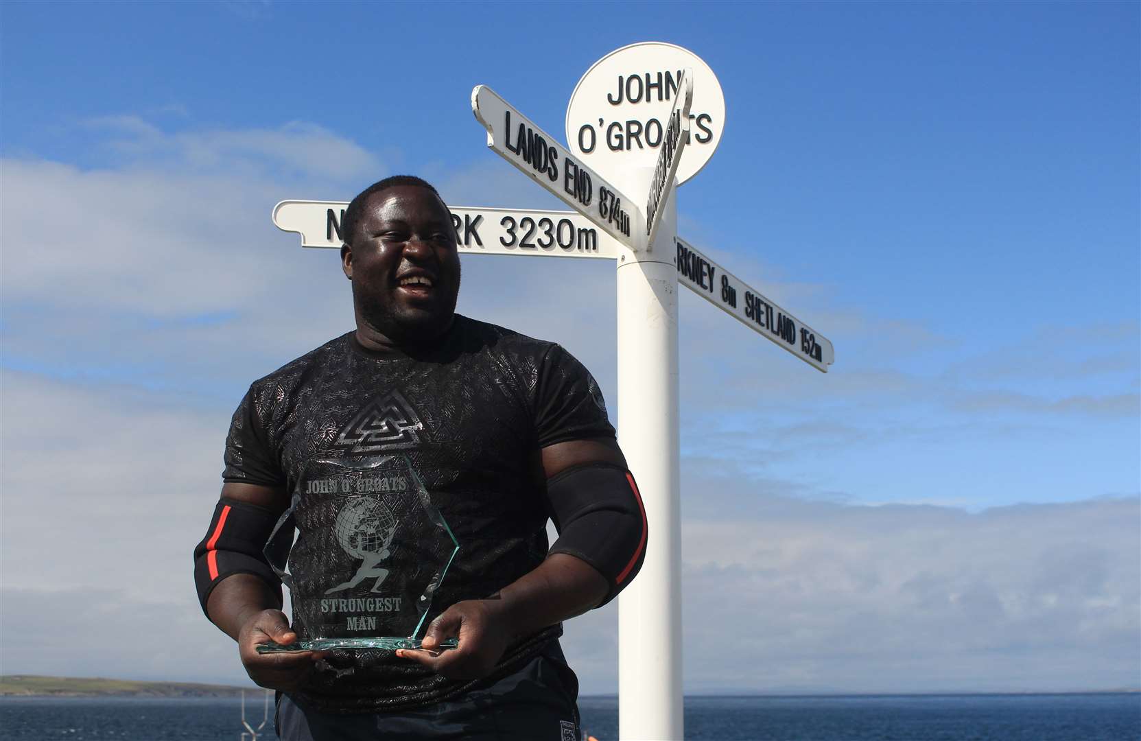 Zake Muluzi, the 'Malawian Monster', with his trophy after winning the John O'Groats Strongest Man competition on Sunday. Picture: Alan Hendry