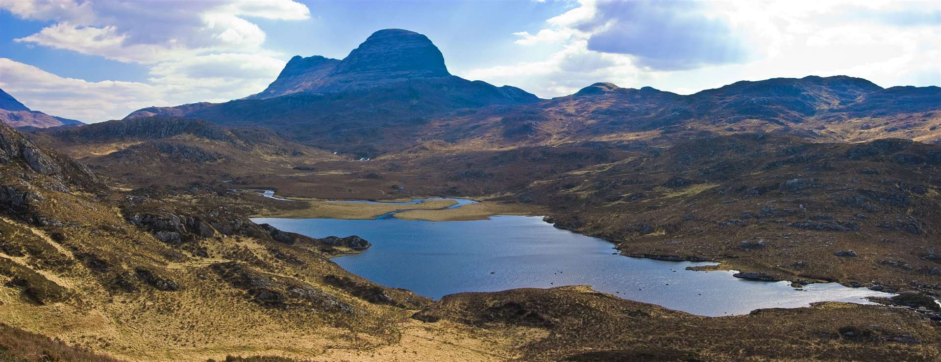 Mount Sulven with a small loch in the foreground in the Asynt region of the western highland of Scotland