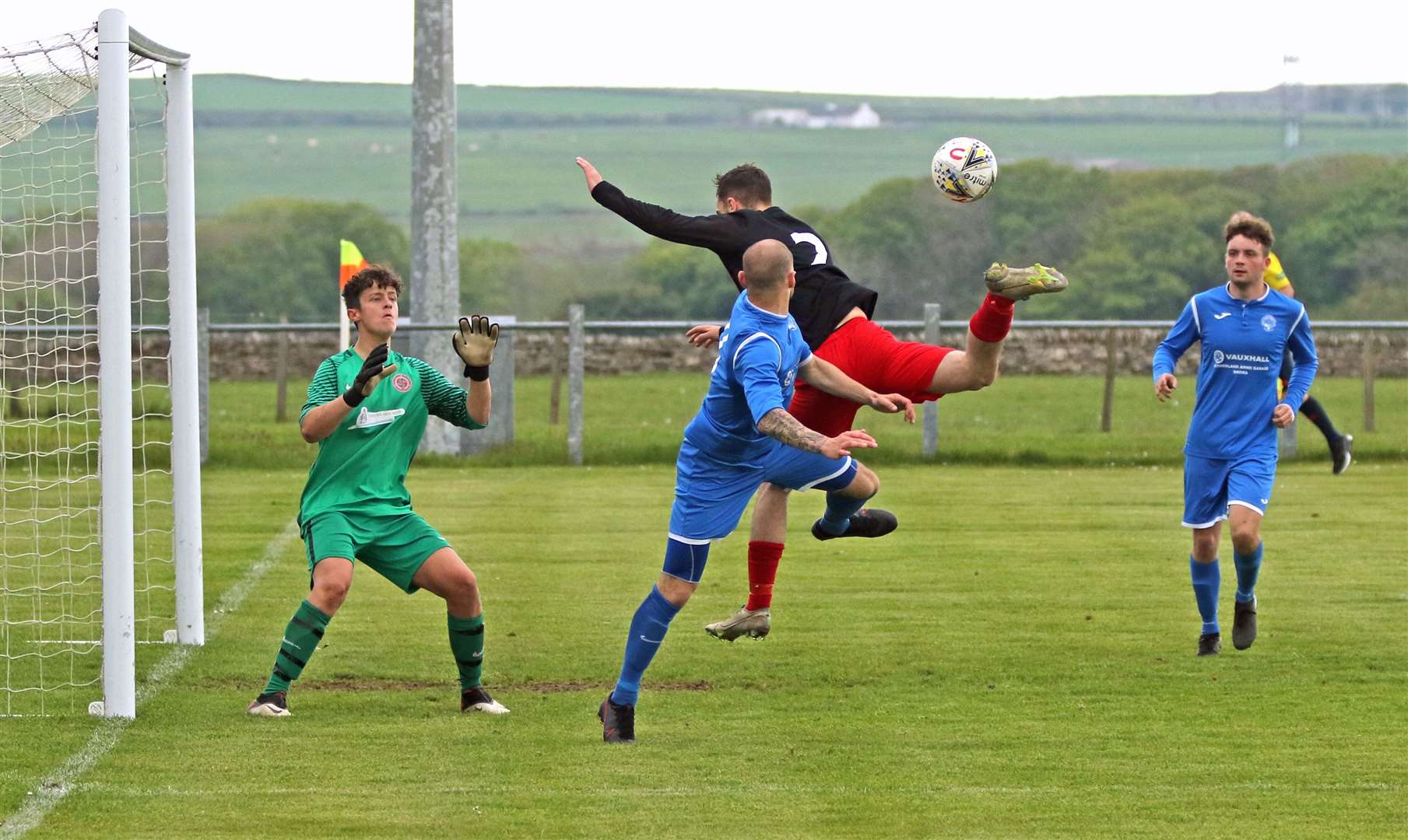 Halkirk United defender Ian Ross gets in a tangle with Golspie's Sean Munro as the Anglers' keeper Lewis Gallacher looks on. Picture: James Gunn