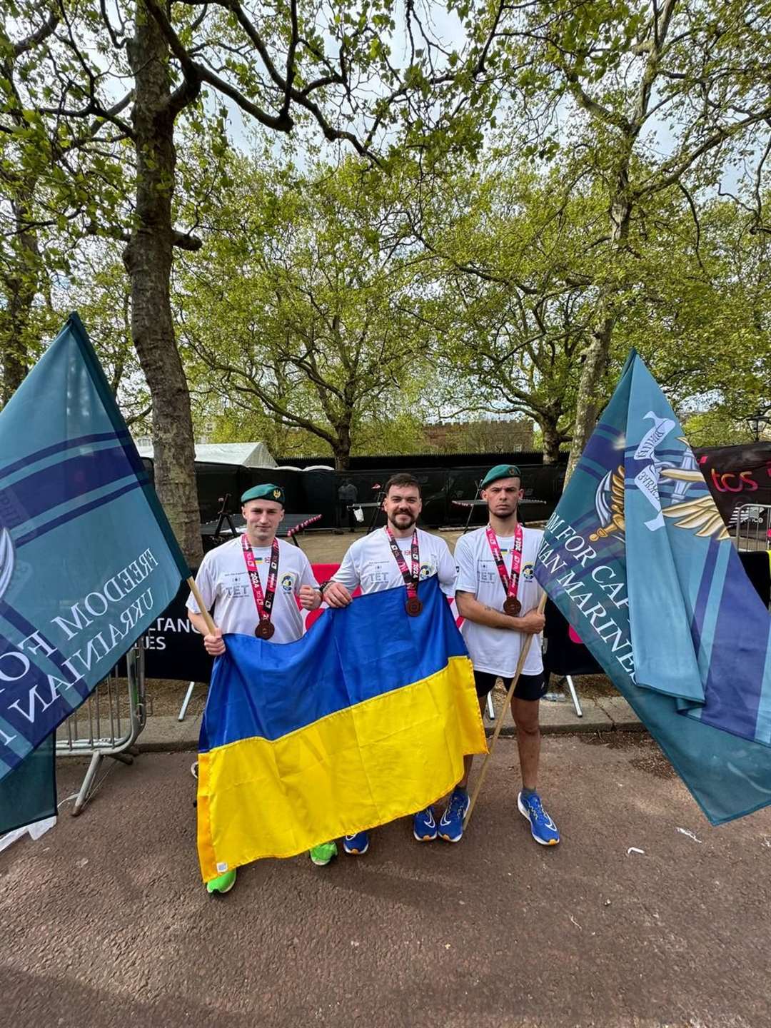 Oleksii Rudenko and Heorhii Roshka at the London Marathon with adaptive athlete and rehabilitation coach Slava Kulakovskyi (Dmytro Morkotonov/PA)