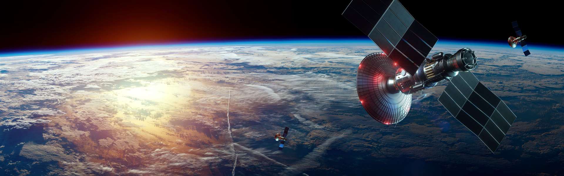 A satellite in space with Earth in the background. Stock Image